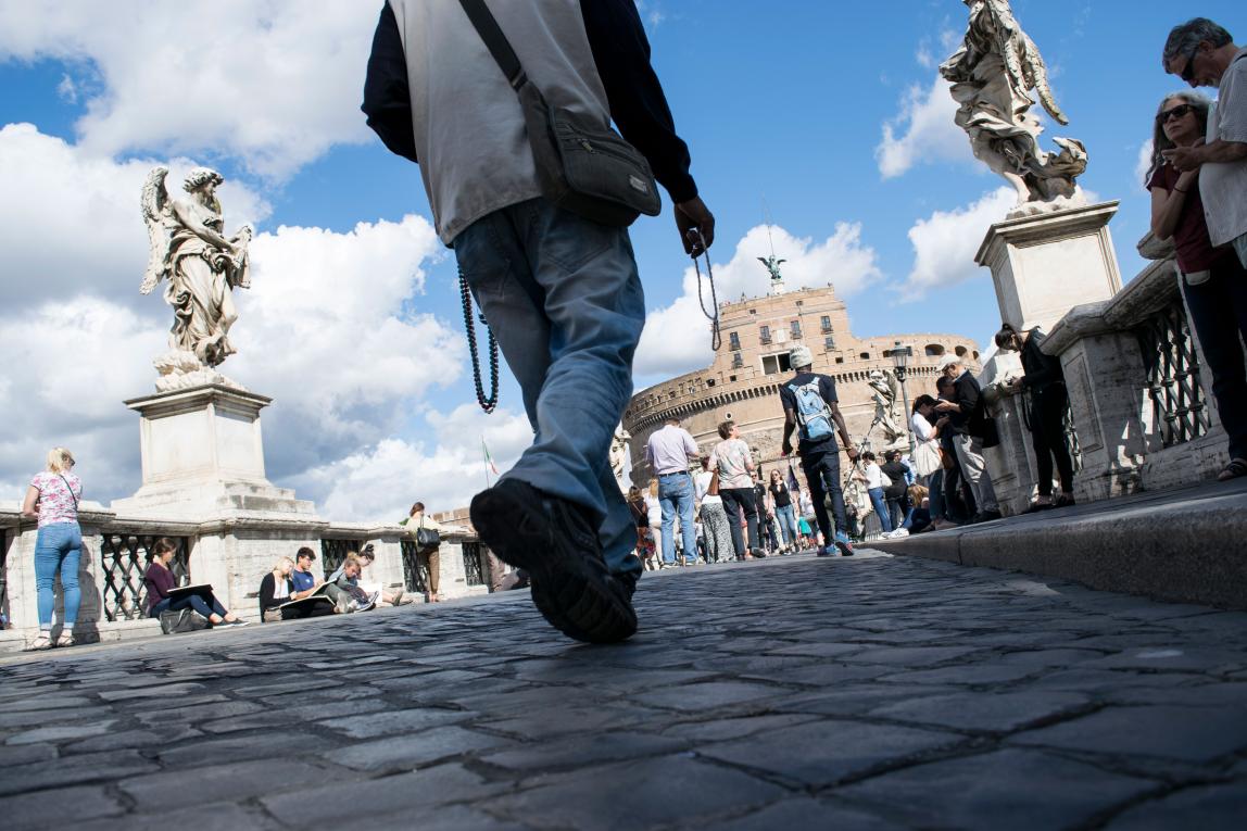 an artistic shot of people's feet as they walk toward Castel Sant'Angelo