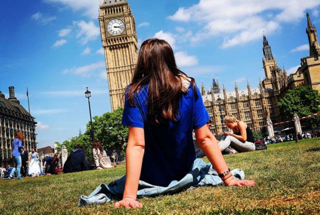 Student sat on grass looking at the Big Ben clock