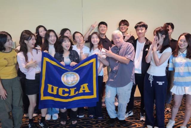 UCLA Extension Study Tour Certificate Ceremony (2025) - group photo of students holding flag