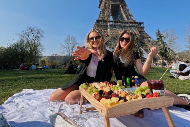 Two students having a picnic at the Eiffel Tower in Paris, France