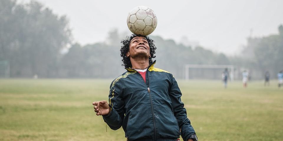 Young adult playing soccer